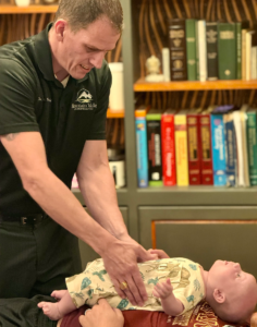 Dr. Joe Heinecke, DC adjusting an infant.