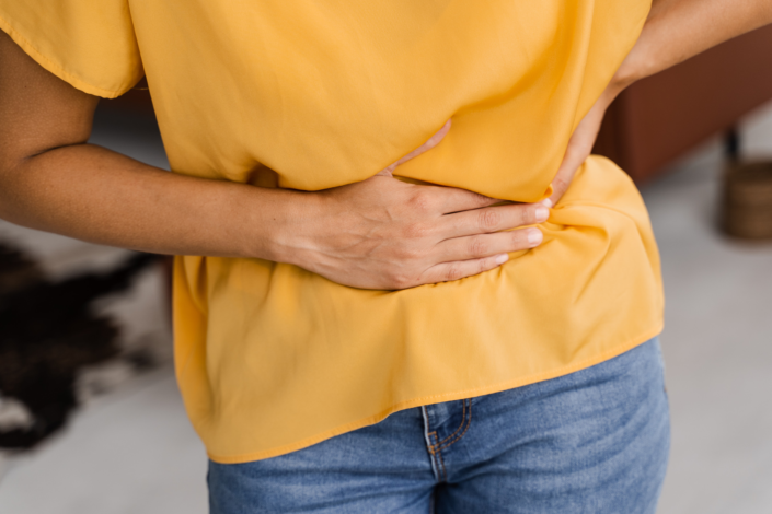 Digestion difficulties - person holding their stomach