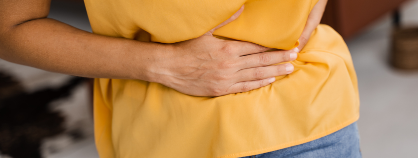 Digestion difficulties - person holding their stomach
