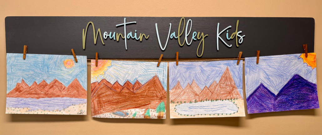Kids play area banner titled Mountain valley Kids displaying kids artwork.