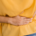 Woman holding her abdomen while experiencing digestive discomfort