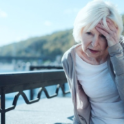 Woman experiencing headache pain and holding her head